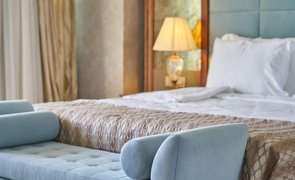 cama arrumada com sofa na frente